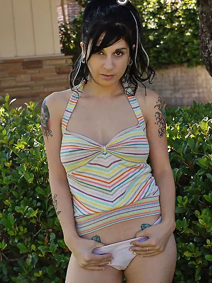 Model with tattoos and a cute boody posing in ther front porch