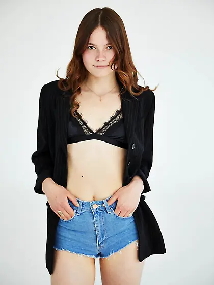 Perky redhead teen poses