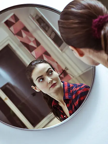 Plaid-loving ponytailed brunette slowly undressing to reveal her