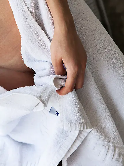 Boozed-up dark-haired seductress shows her pretty pussy on a bed