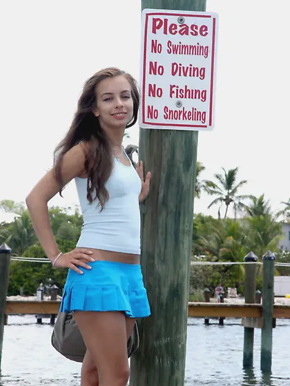 Enticing floozy in a blue bikini BJs on a...