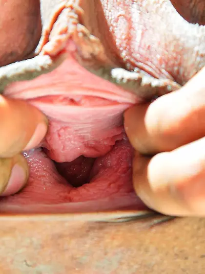 Gaunt young brunette pampering her black pussy with a vibrator