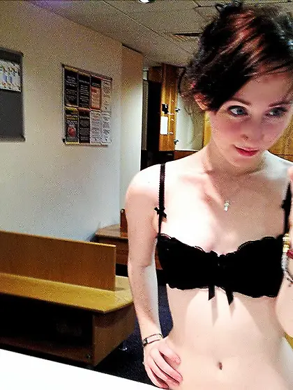 Brunette is showing off her tits in the mirror