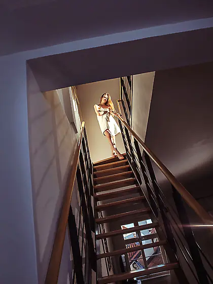 Sensual redhead drops her towel and spreads her legs on the stai