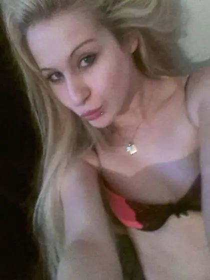 Skinny young blonde is posing in black lingerie