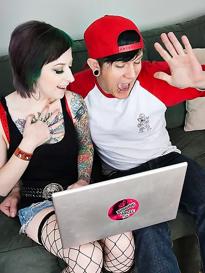 Lubricious young woman with green hair gives her tattooed body t