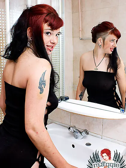 Horny gothic teen babe Red Maggie applies make up in the toilet