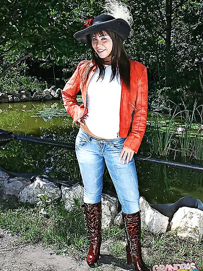 Young girl in boots undresses to flaunt her tempting naked body