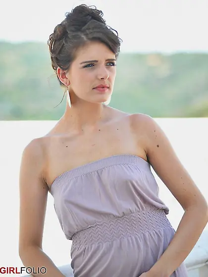 Gorgeous brunette reveals her perky assets during outdoor erotic