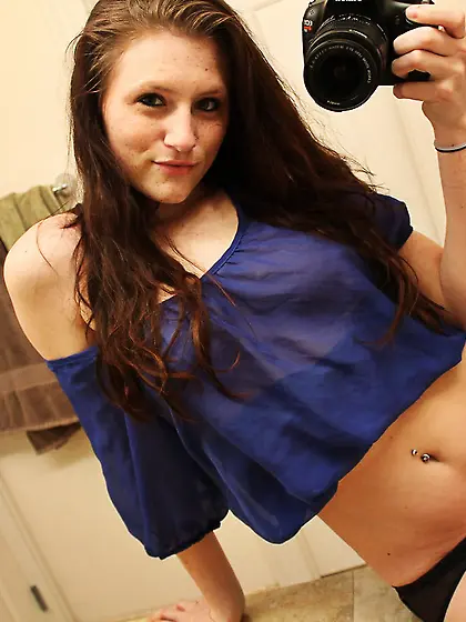 Freckles takes photos of herself in the mirror and we see her bo