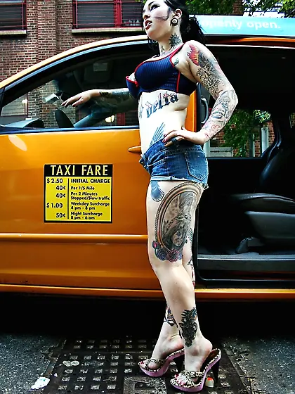 Tattooed cutie waits for a taxi driver and performs a naked show
