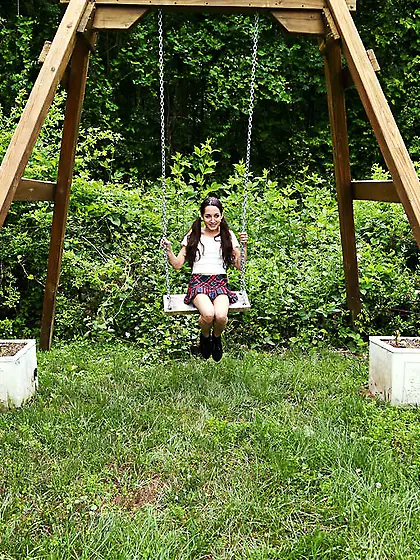 Pigtailed college girl in boots has fun with pussy spreader sitt