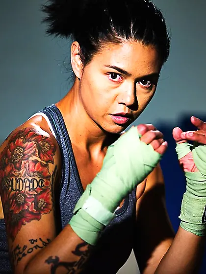 Exotic tattooed fighter in ponytail posing...