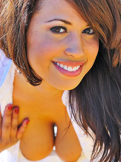 Brunette with a charming smile shows her flower after picking fl