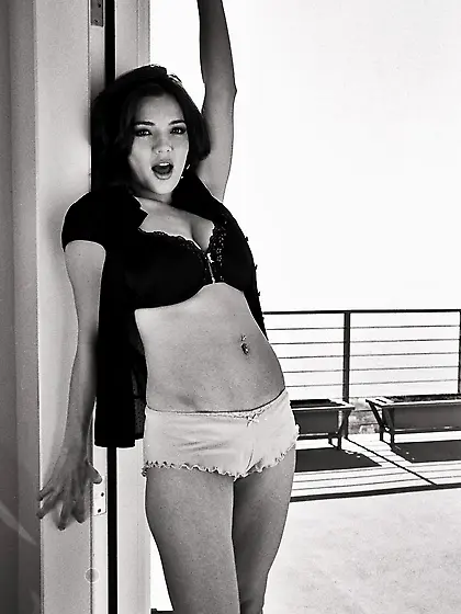 Sexy redhead babe Danielle Riley with big melons posing on the b