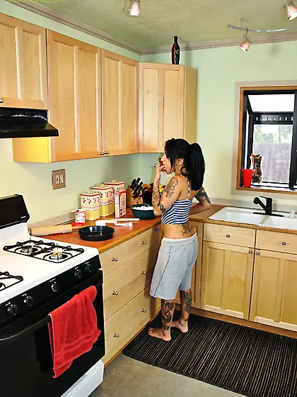 Horny brunette babe Capri Cavalli strips her clothes and fucks w