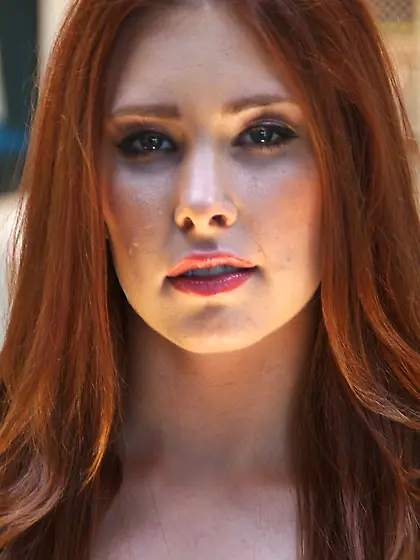 Temptress with red hair knows how to dress up to make guys horny