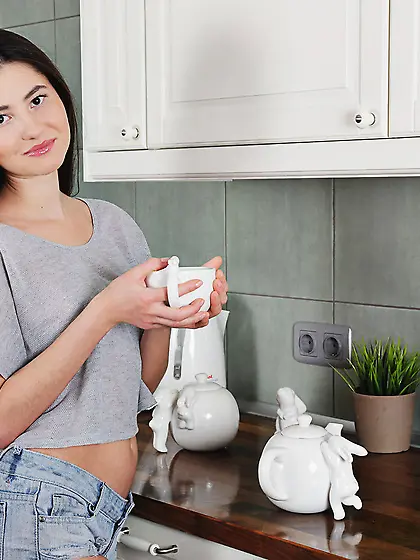 Denim shorts brunette in a grey top undressing sensually in the