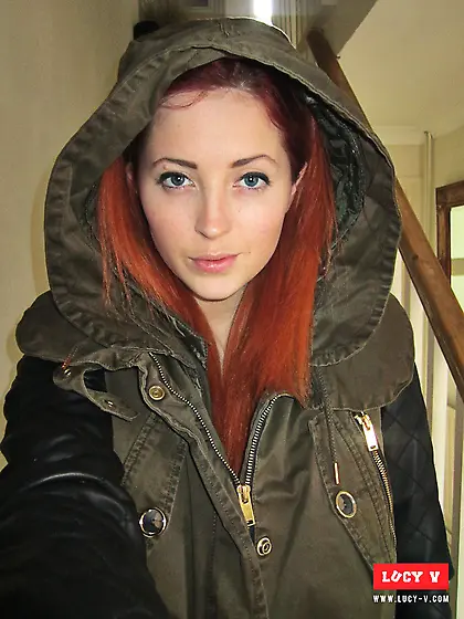 Sassy Lucy Vixen is taking off her rain coat demonstrating big n
