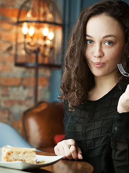 Playful brunette with curly hair exposing her hairy pussy on a s