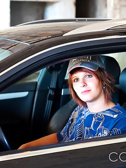 Slutty redhead comes to the garage to pose with her huge saggy t