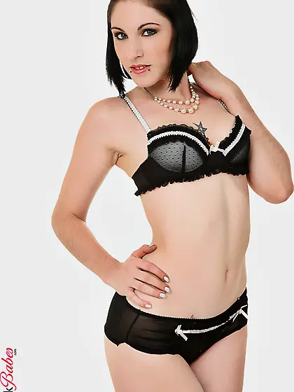 Charming brunette babe Darla Demonia strips her black lingerie a