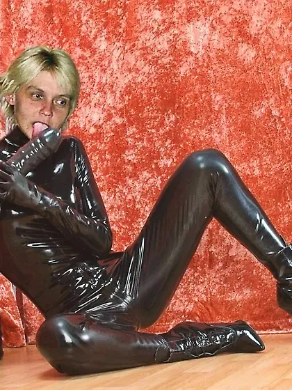 girl in black catsuit licking her dildo