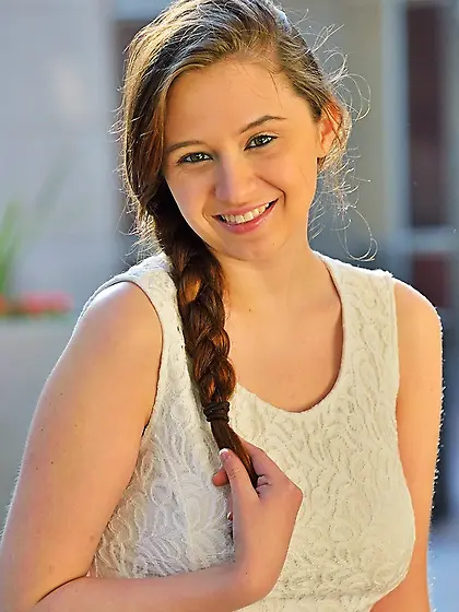 Teen seductively sits escalator