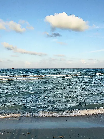 Mia Bella posing on the beach and rubs her nasty and shaved puss