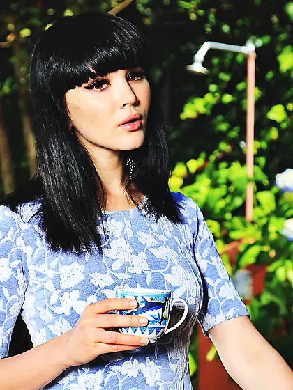 Dark-haired hottie with stylish bangs leaves her electric blue s