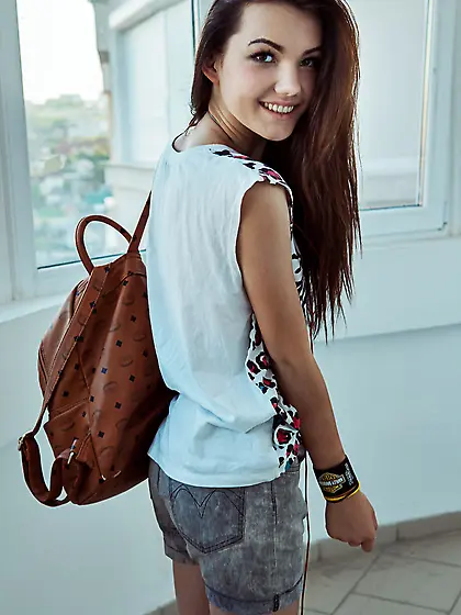 Woman of pleasant visage comes home and gets undressed to drink