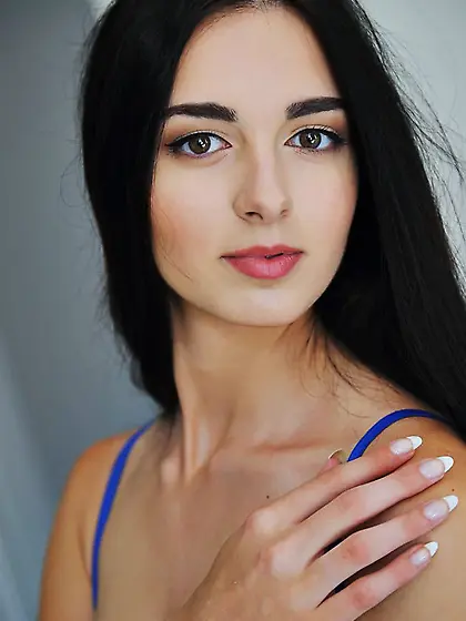 Raven-haired and flat-chested hottie shows her trimmed cunt for