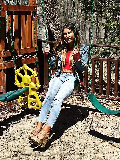 Hottie in denim jacket licks a lollipop and plays with pussy on