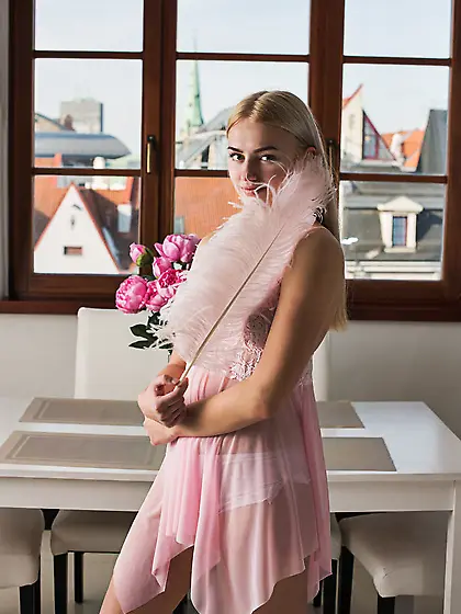 Blonde takes off nightie and shows unshaved crotch with a feathe