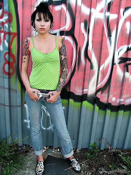 Black-haired young cutie shows off her tiny ass outdoors while s