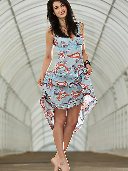 Dress-wearing beauty takes off her tiny white panties and poses