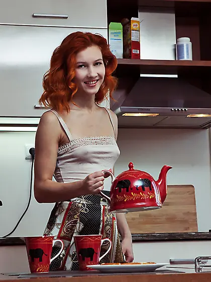 Curly-haired redhead spreading her slender legs in the kitchen V