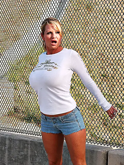 Busty blonde gal Kelly Madison takes off her clothes and shows h