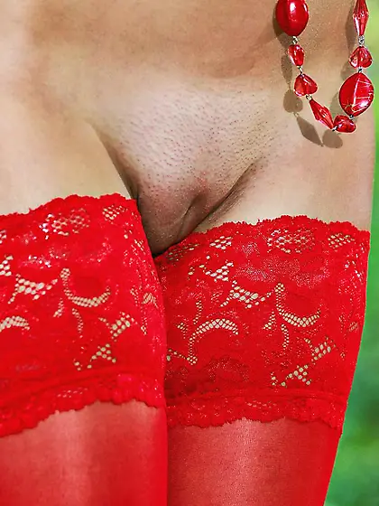 Hottie Violla A has her red opaque stockings on when posing outd