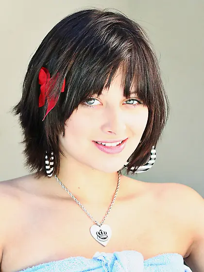 Frisky smoker Ellie Idol with red flower in her hair shows her b